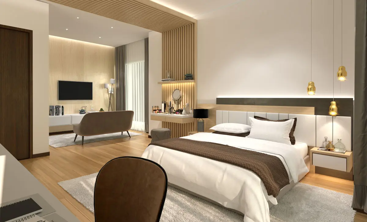 Bedroom with a slatted timber wall, pendant bedside lights and a lounge chair
