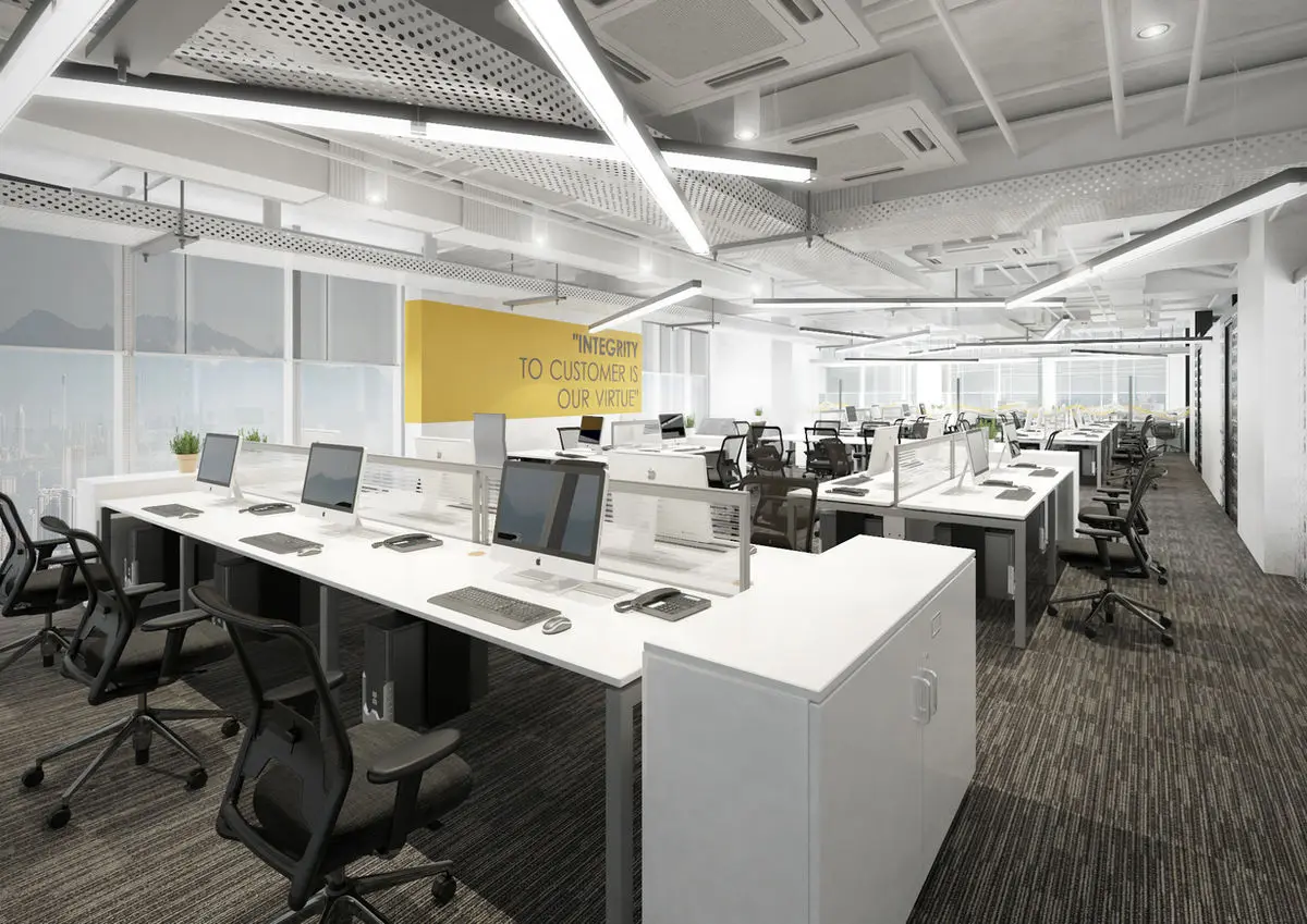 Open-plan office with rows of white workstations, exposed services and a yellow wall graphic