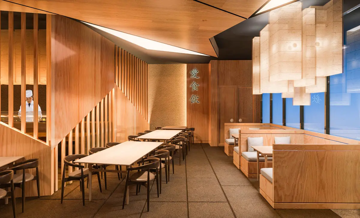 Japanese restaurant with timber panelling, a long counter and paper pendant lights