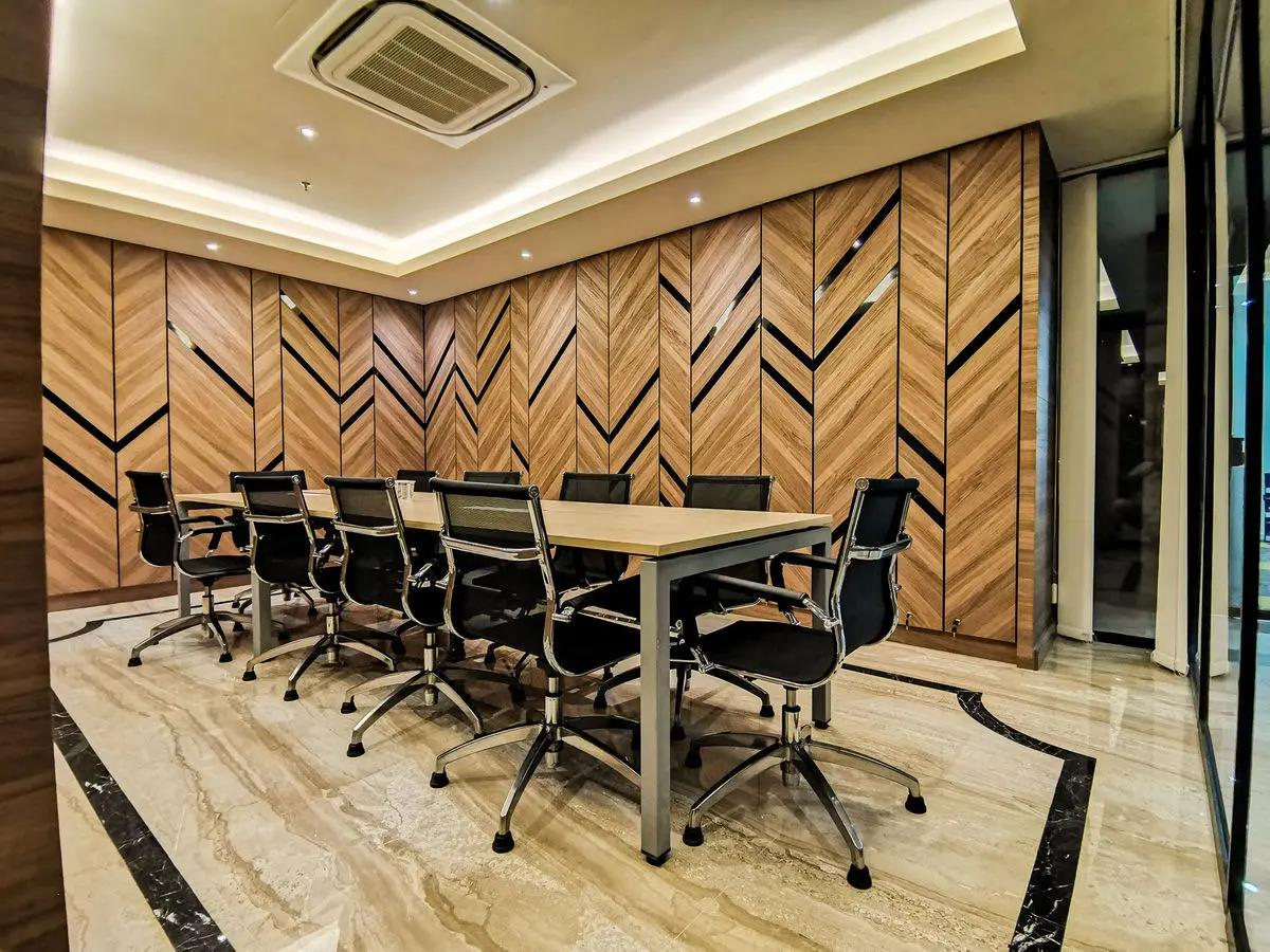 Meeting room with a herringbone timber feature wall and a long conference table