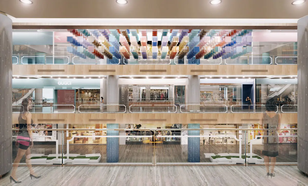 Mall atrium with a colourful patterned ceiling feature above tiered shopfronts