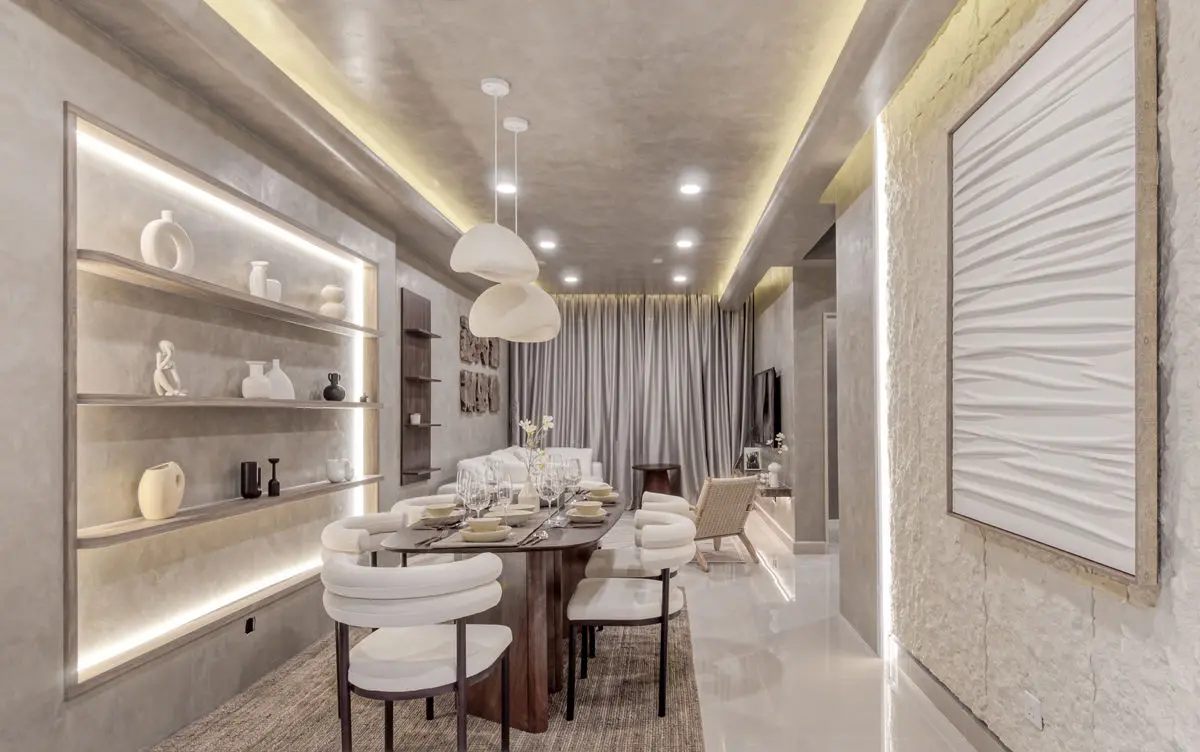 Living and dining space with micro-cement walls, recessed lit shelving and a rounded dining set