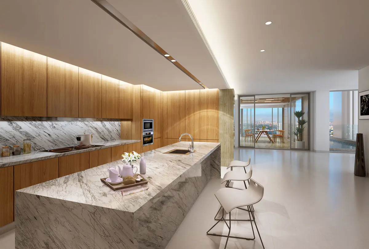 Open kitchen with a marble waterfall island, timber wall cabinets and built-in ovens