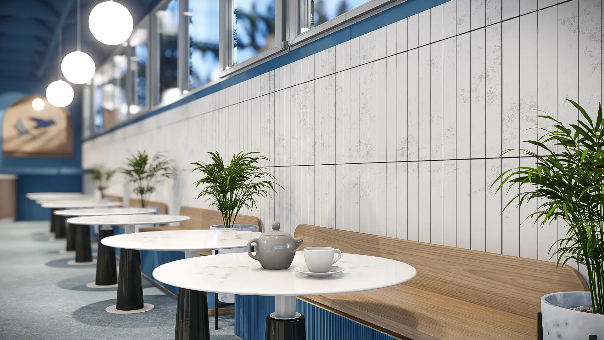 Cafe seating with white marble bistro tables, oak banquette, globe pendants and blue panelling