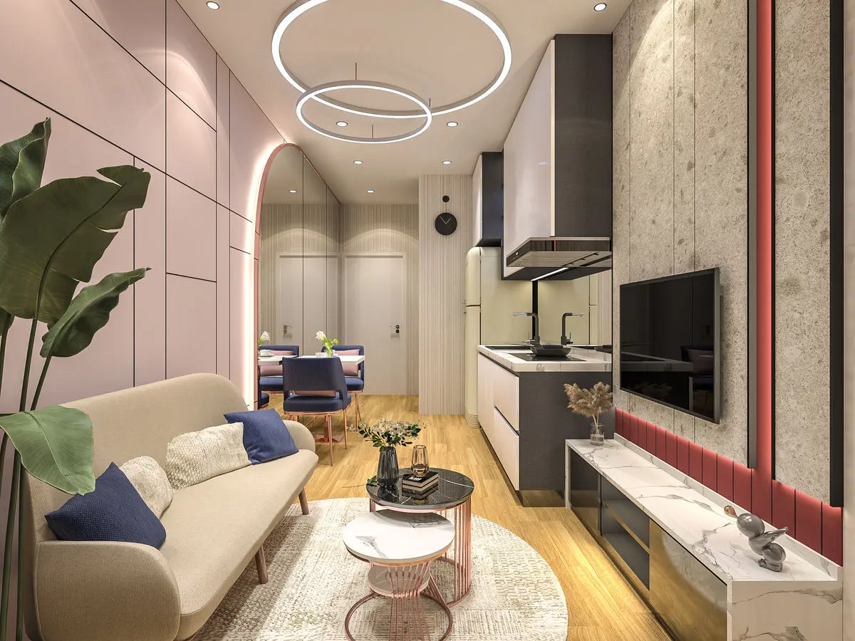 Compact living area with a marble TV wall, ring pendant light and a kitchenette beyond