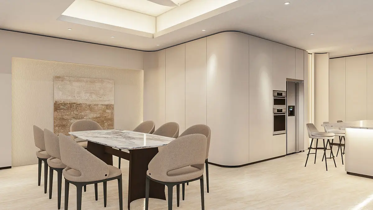 Dining area with an oval table, curved cabinetry and a kitchen counter beyond