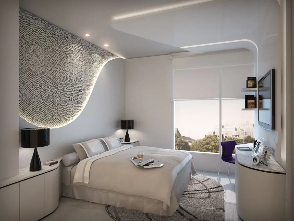 Bedroom with a curved backlit ceiling, patterned headboard panel and a window seat