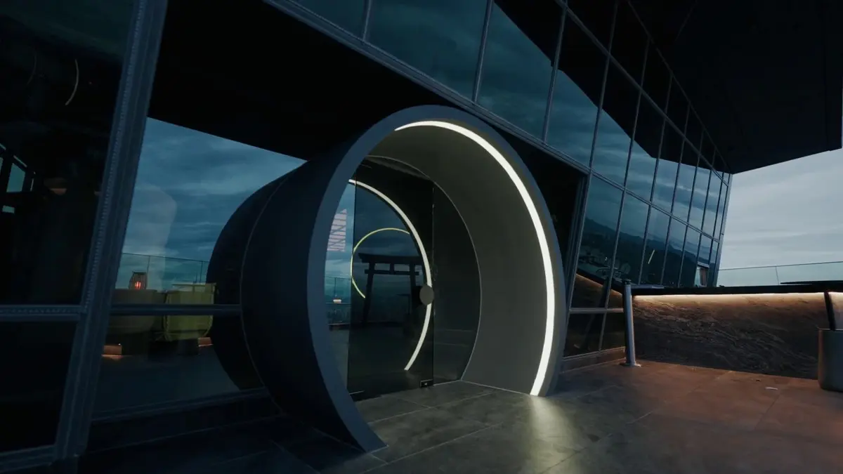 Rooftop bar entrance with a circular illuminated portal framing the city skyline