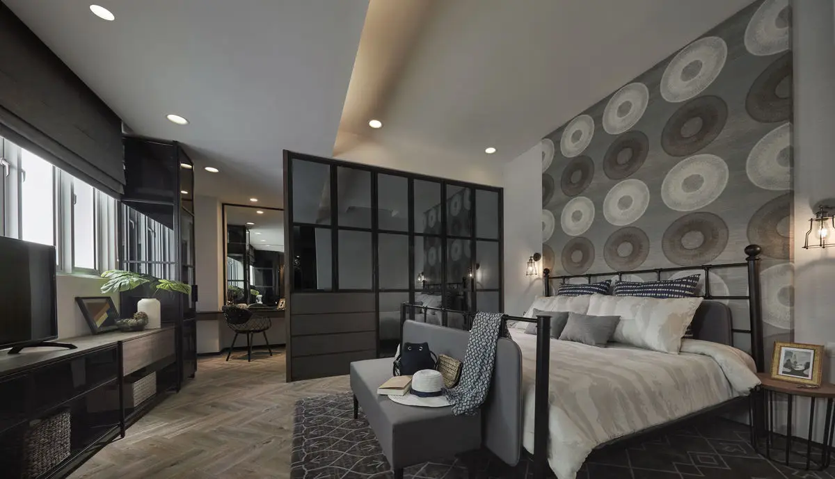 Bedroom with a patterned feature wall, black-framed glass partition and a metal bed frame
