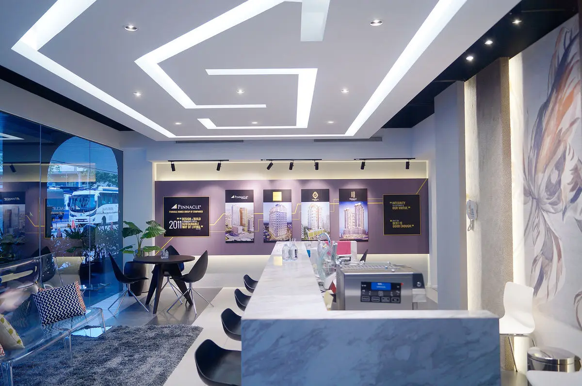 Sales gallery with a geometric ceiling, a stone counter and consultation seating