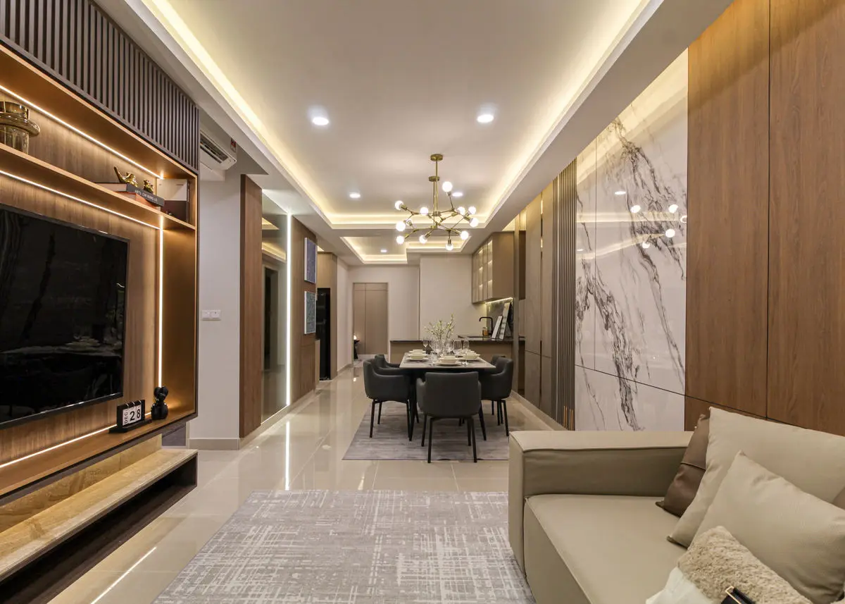 Living and dining area with a marble TV feature wall, chandelier and pale sofa