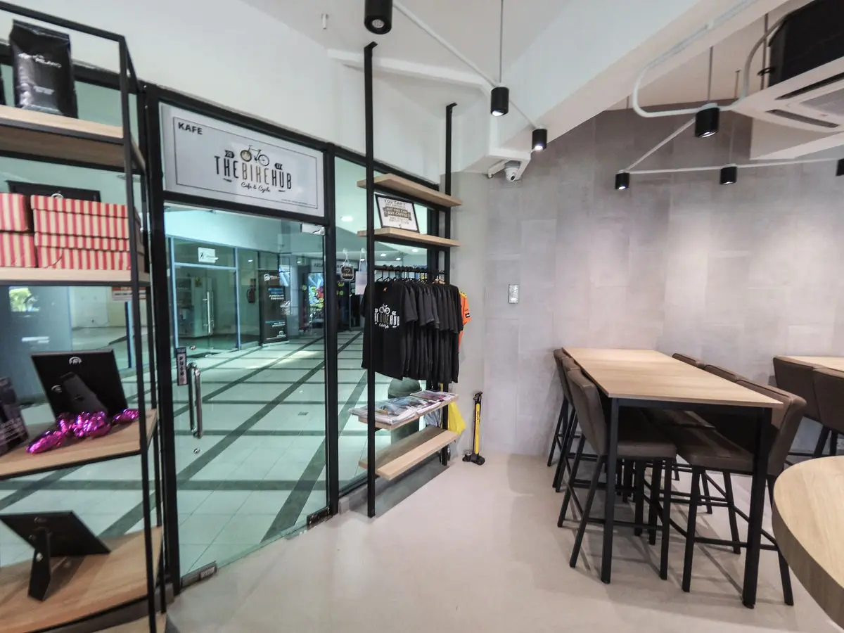 Glazed shopfront with merchandise display and bar seating inside