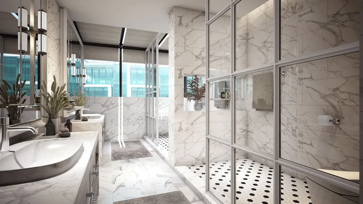 Marble bathroom with a built-in tub, glass shower screens and patterned floor tiles