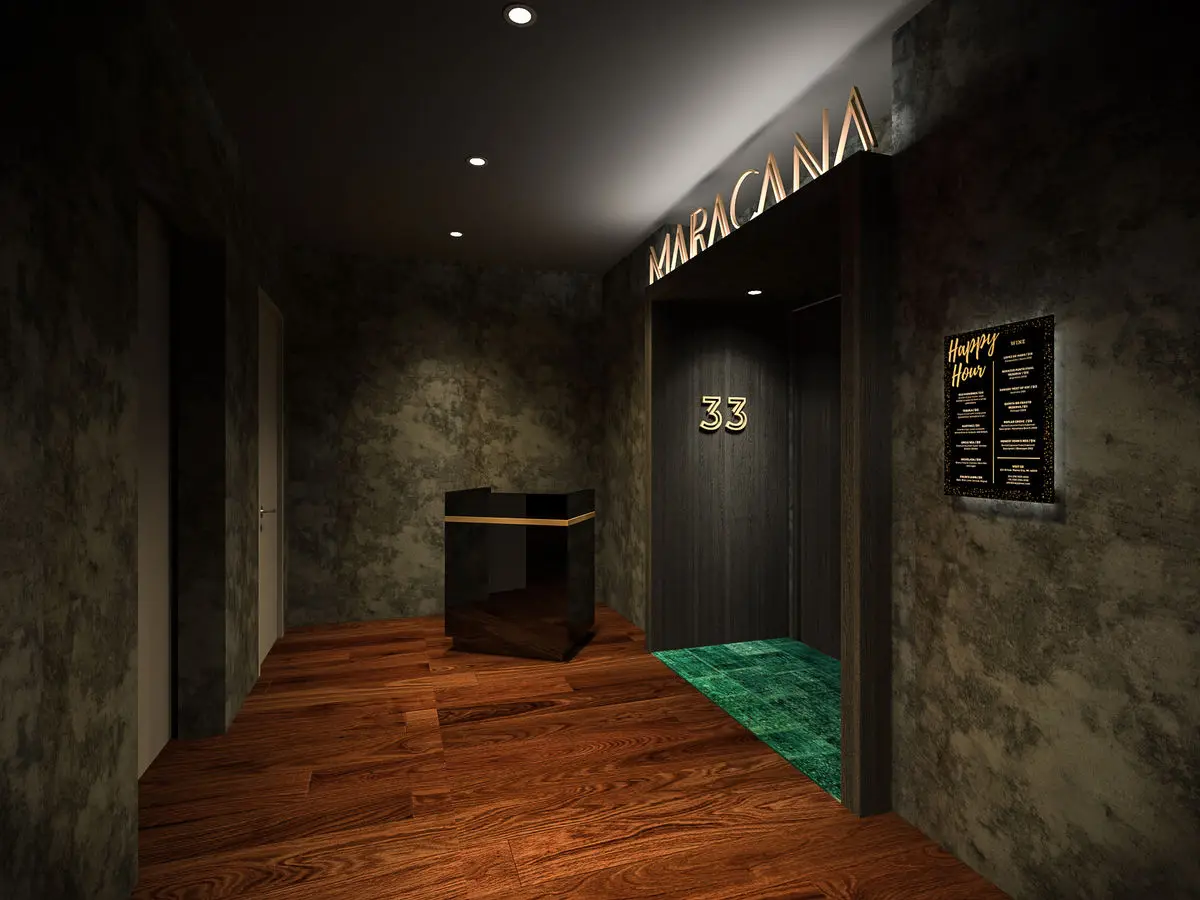 Entrance corridor with textured dark walls, timber flooring and backlit signage