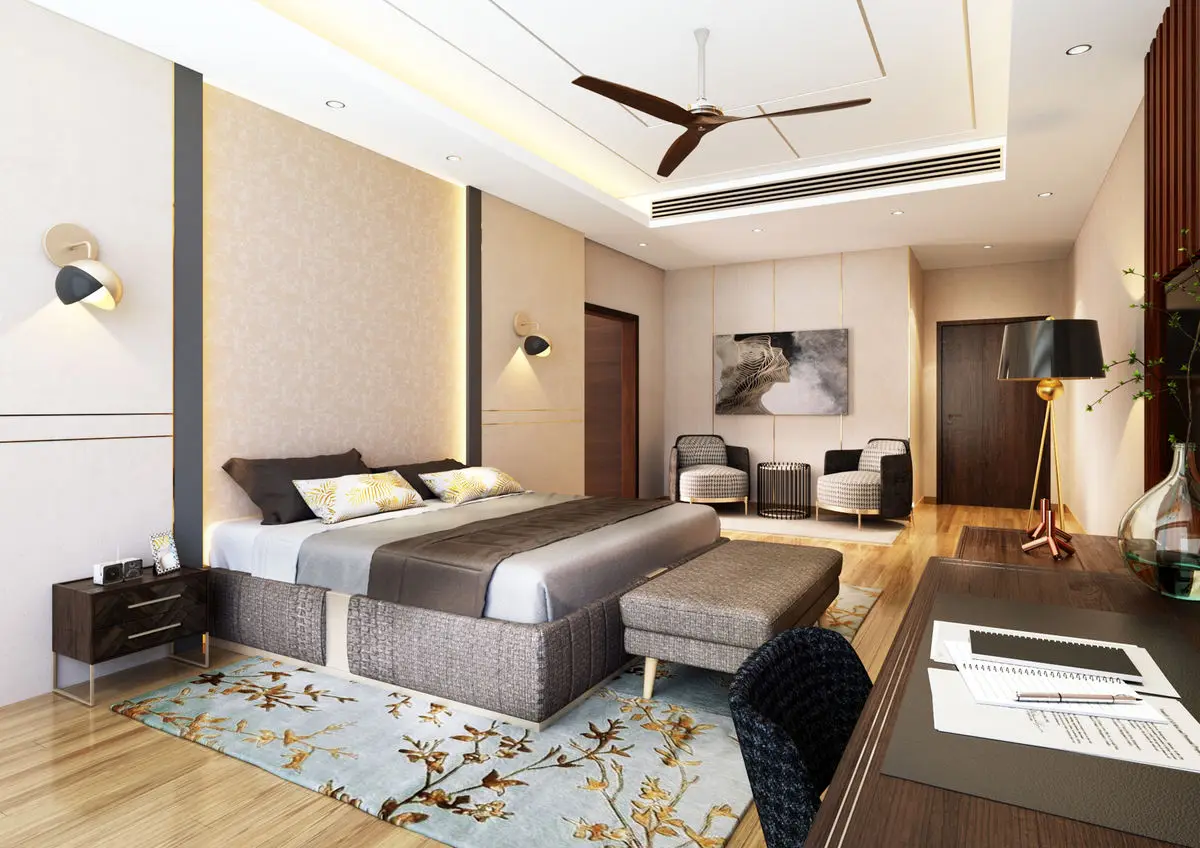 Bedroom with an upholstered wall panel, patterned rug and a chaise at the foot of the bed