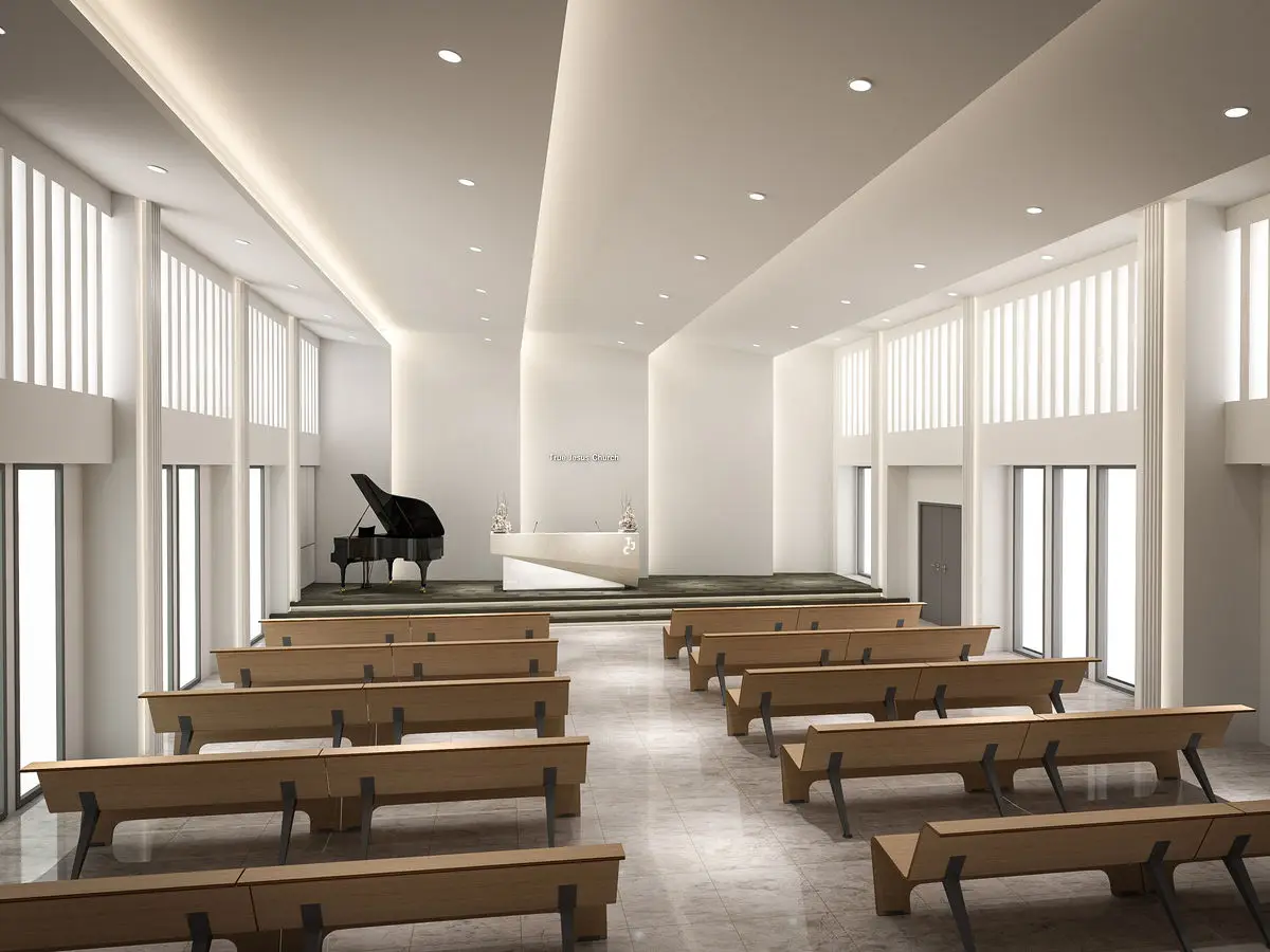 Church hall with timber benches, a stepped platform and tall windows