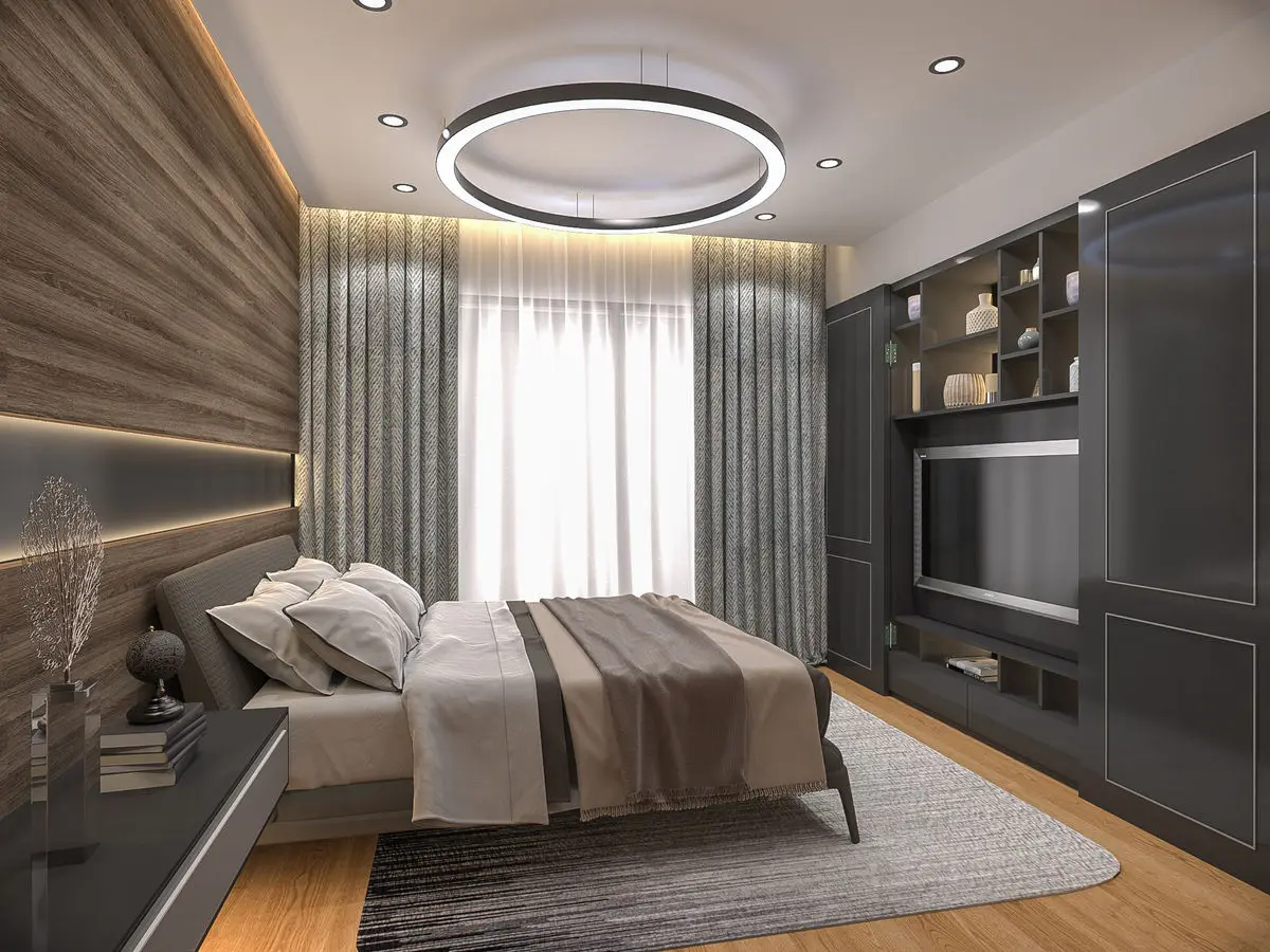 Bedroom with a stone-look headboard wall, ring pendant light and a dark TV cabinet run