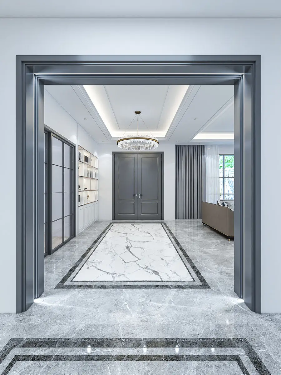 Entrance hall framed by a wide grey portal, with an inset marble floor panel and double doors