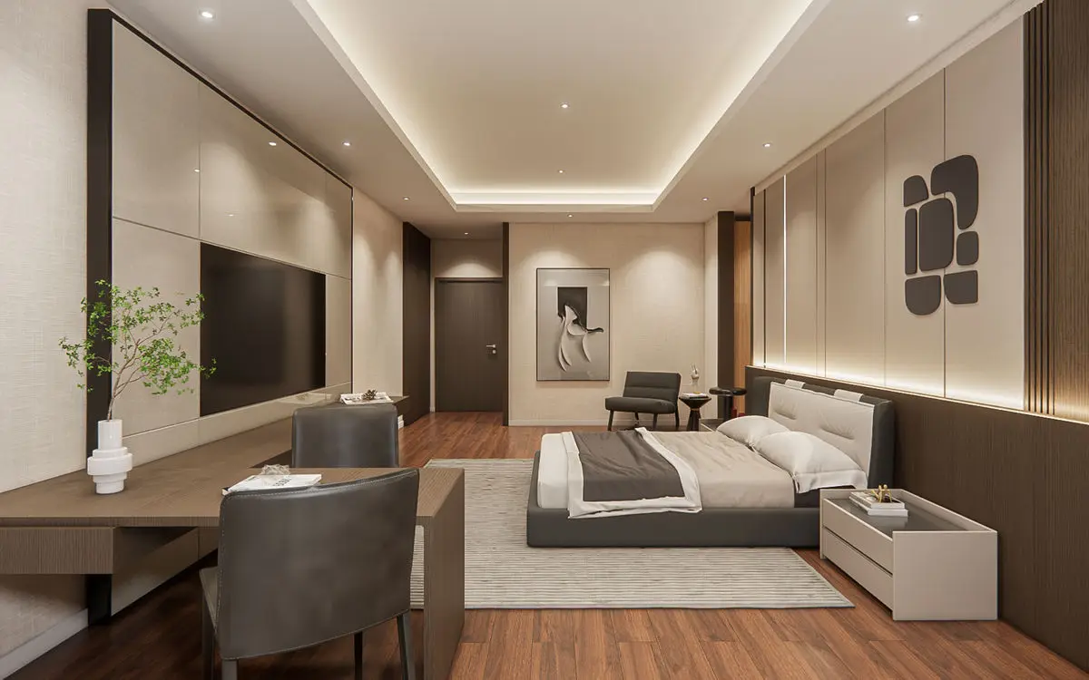 Bedroom with a wall-mounted TV, upholstered bed and armchairs by the desk