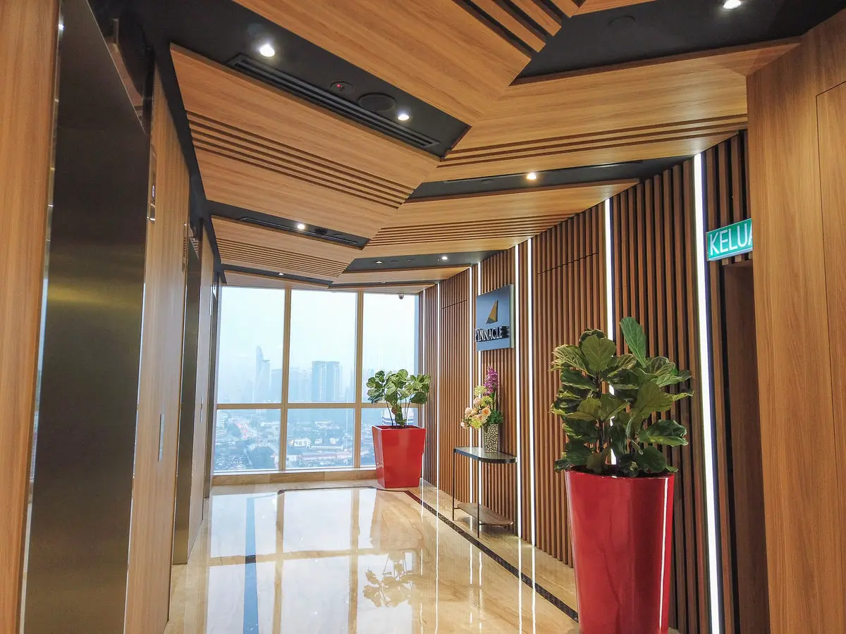 Lift lobby with timber ceiling battens, marble flooring and a city view