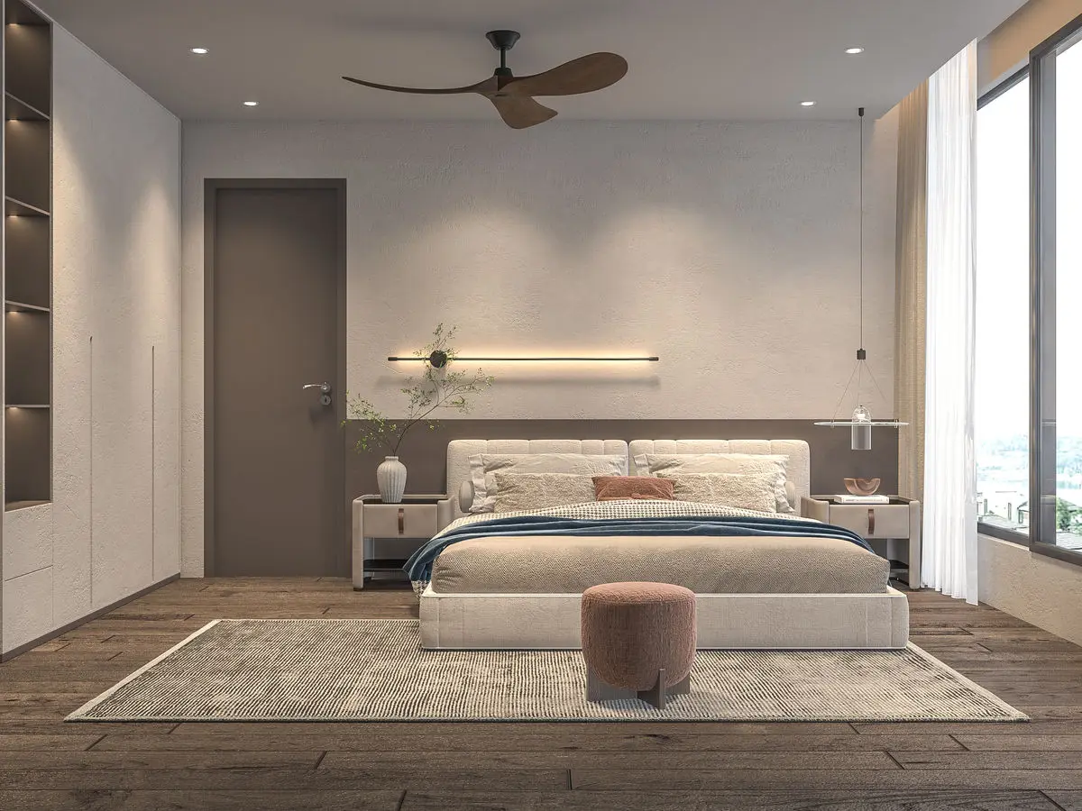 Bedroom with a plaster feature wall, upholstered bed and a rug on timber flooring