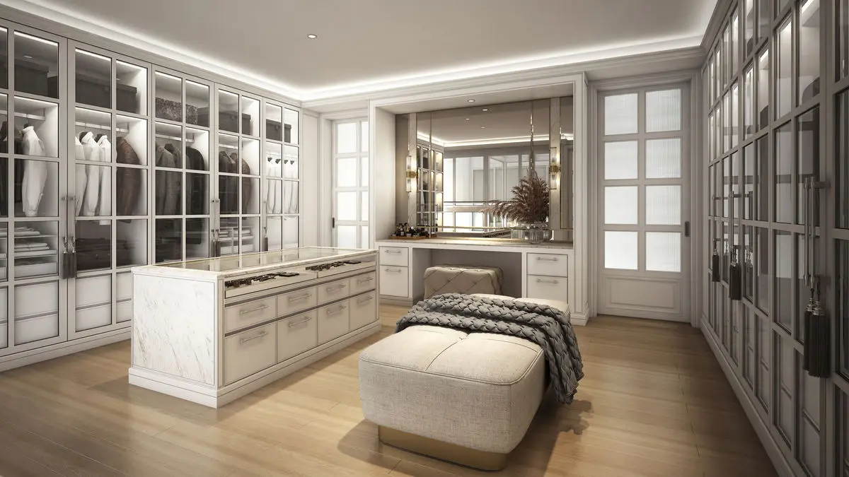 Walk-in wardrobe with glazed cabinet doors, a central island and dressing bench