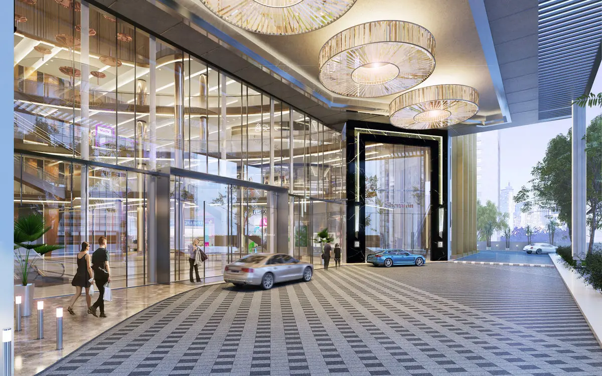 Mall entrance and drop-off at dusk with drum chandeliers