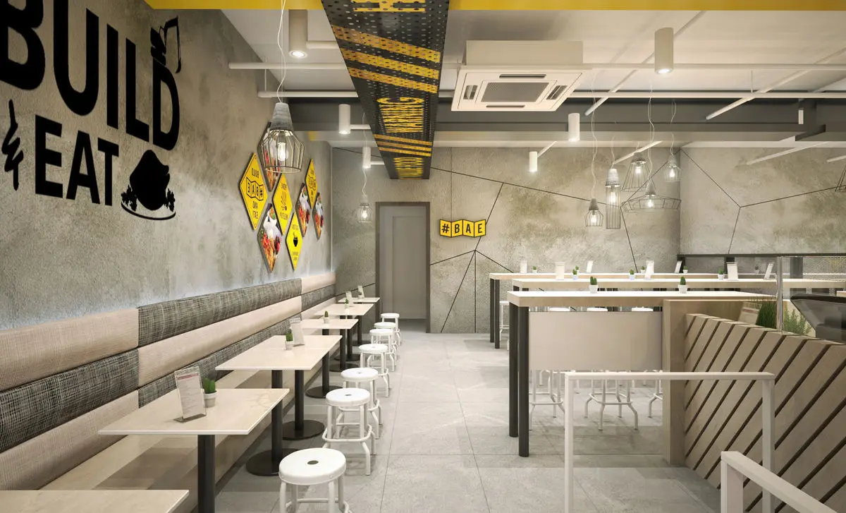 Dining room with concrete walls, banquette seating and stools at slim tables