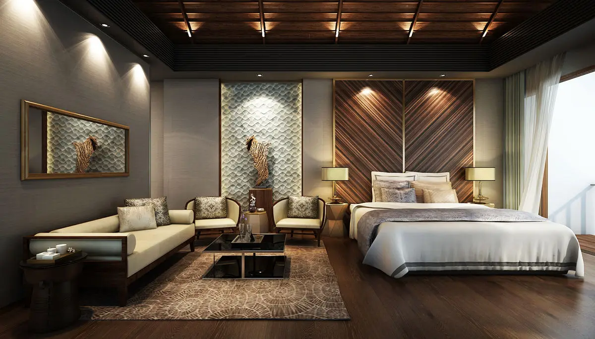 Bedroom with a timber headboard wall, lounge seating and a coffered timber ceiling