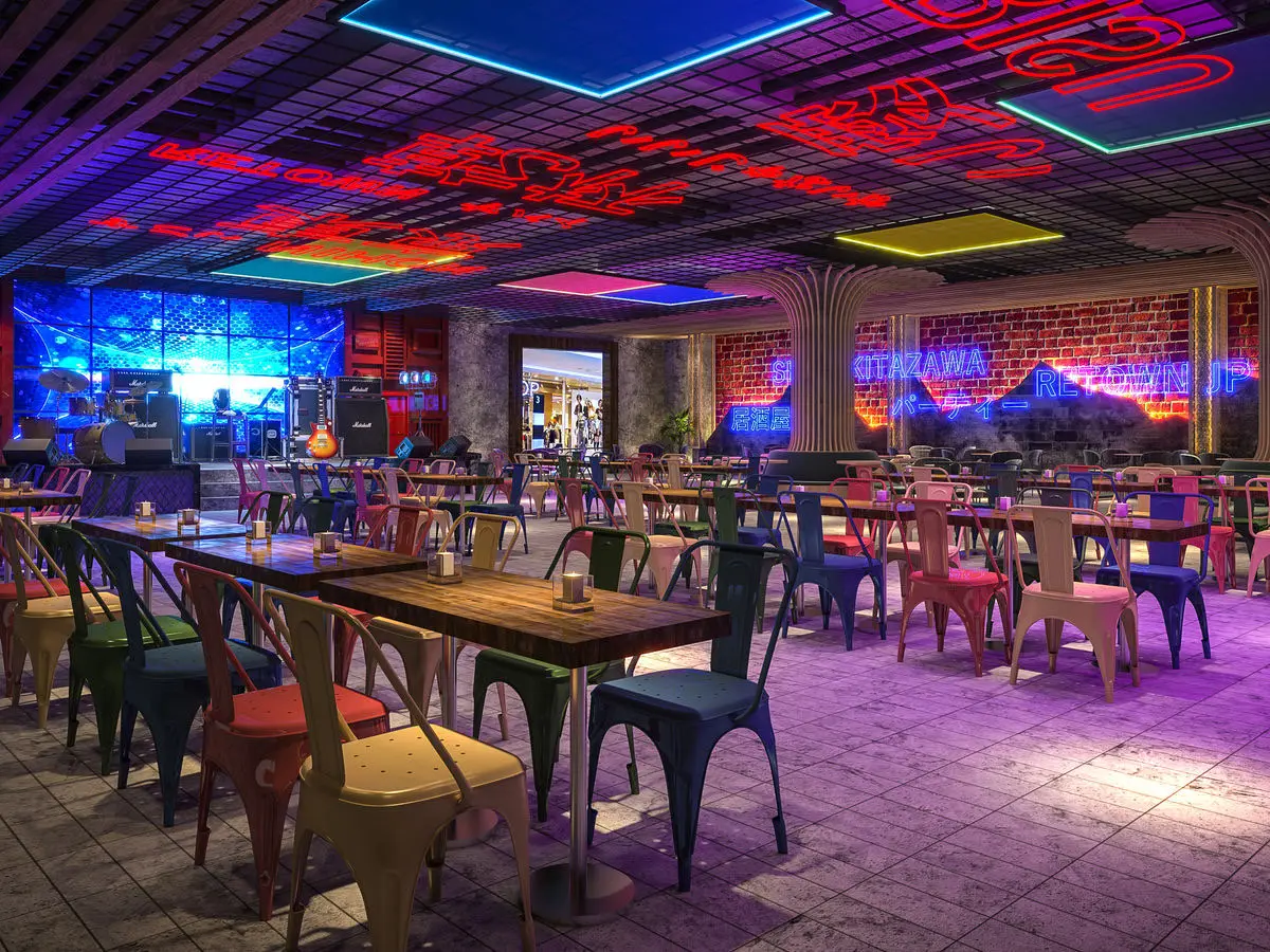 Live music venue with coloured neon ceiling lights, brick walls and mixed seating
