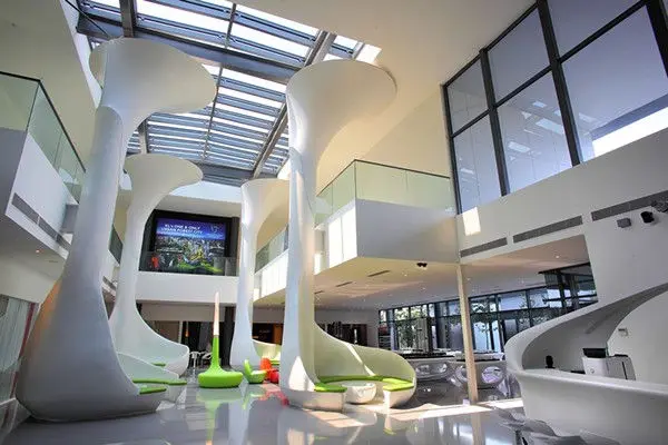 Double-height atrium with sculptural columns and a mezzanine walkway