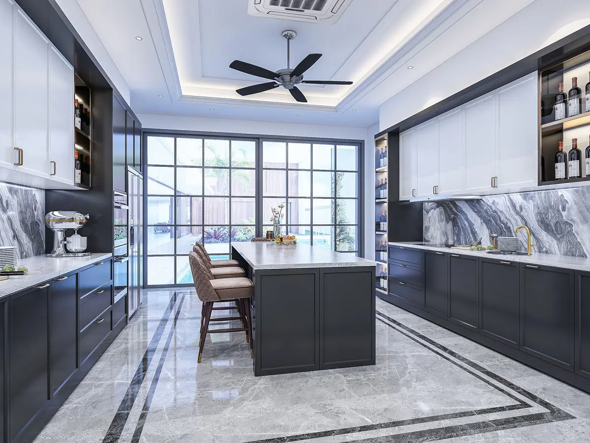 Kitchen with navy cabinetry, marble backsplash and island, and a breakfast bar by the window
