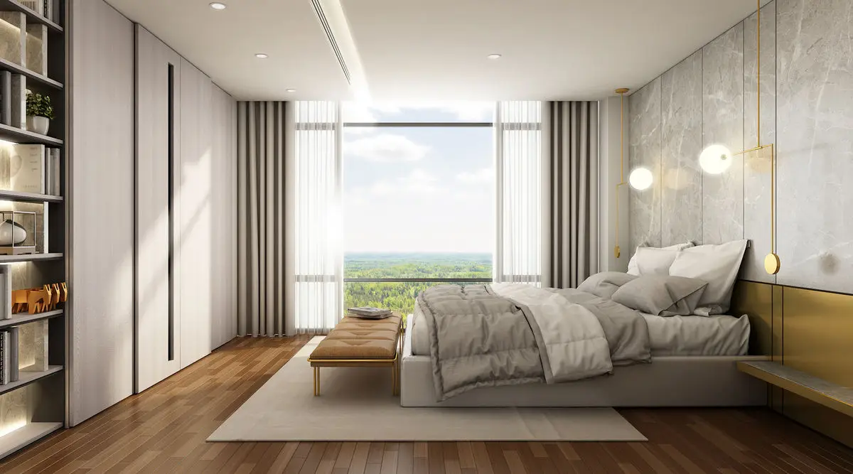 Bedroom with a stone feature wall, timber flooring and a window overlooking greenery