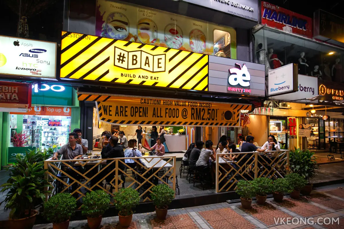Restaurant frontage on a shop street with outdoor seating and planters