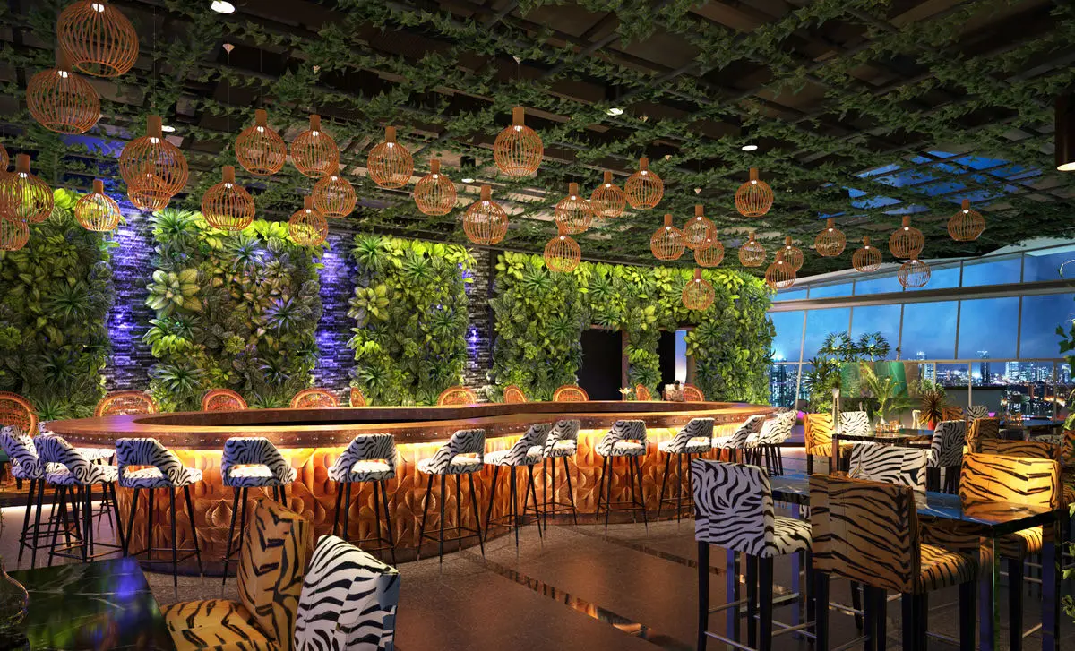 Bar with a living plant wall, rattan pendant lights and patterned stools
