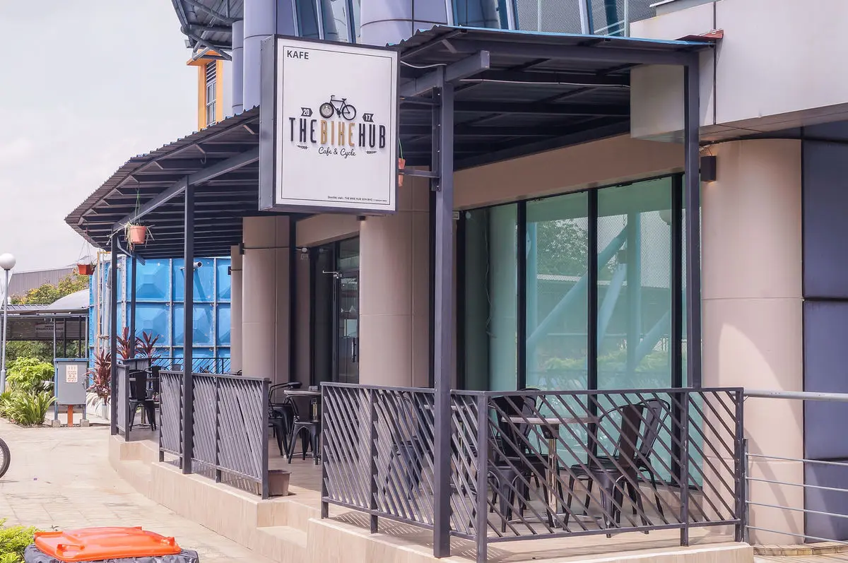 Exterior of the bike café with signage and a bike rack