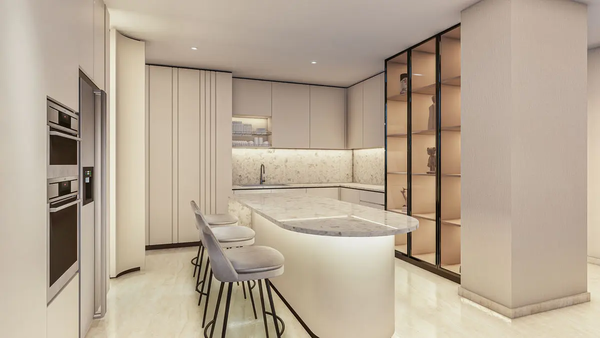 Kitchen with a curved island, bar stools and glass-framed pantry doors