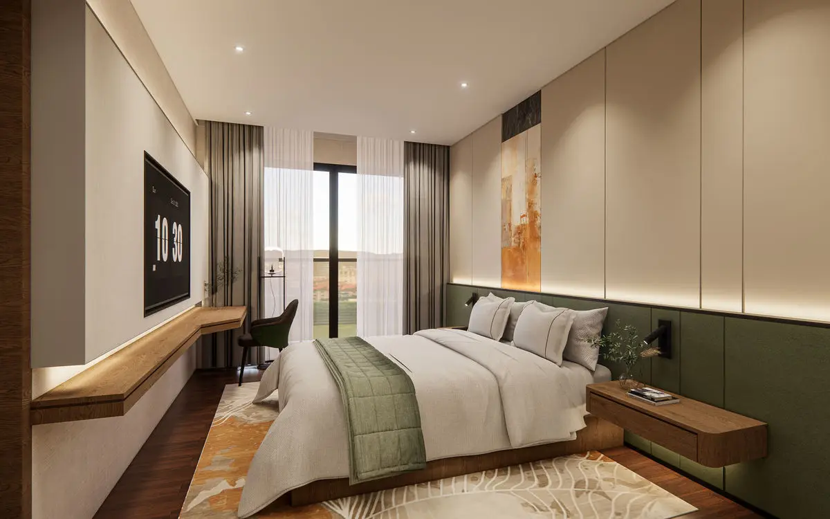 Bedroom with a green headboard panel, built-in desk and full-height wardrobes