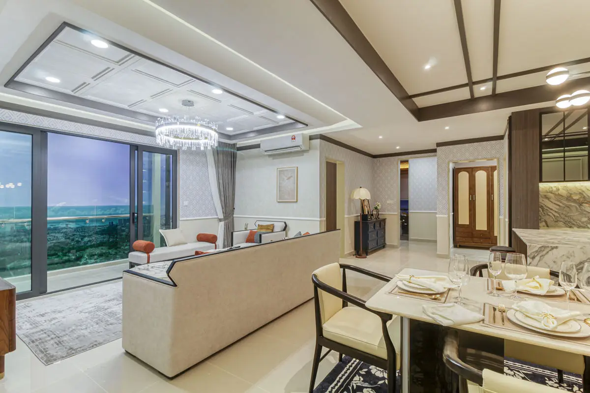 Living and dining area seen from the sofa, with the balcony beyond and a set table