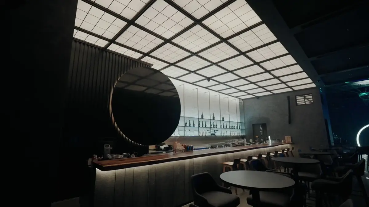 Bar counter with a large dark disc feature, grid-lit ceiling and low stools