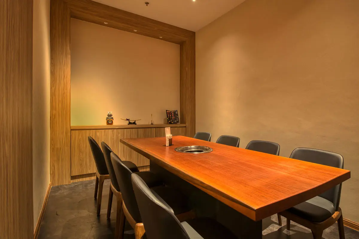 Private dining room with a long timber table and a recessed alcove