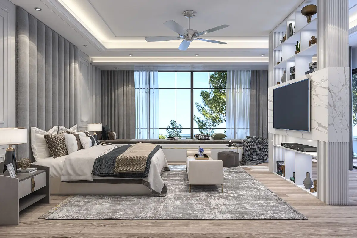 Bedroom with an upholstered headboard, wall-mounted TV, backlit display shelving and a window seat