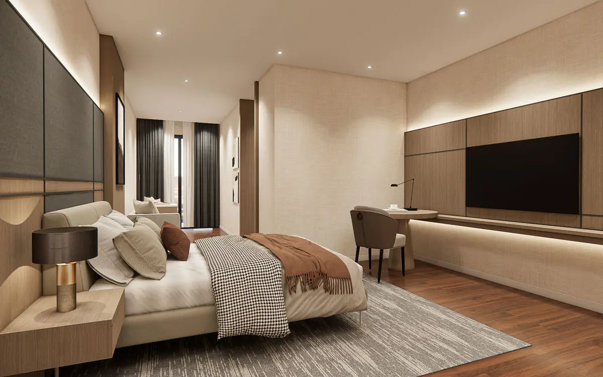 Bedroom with a padded headboard, long TV console and timber flooring