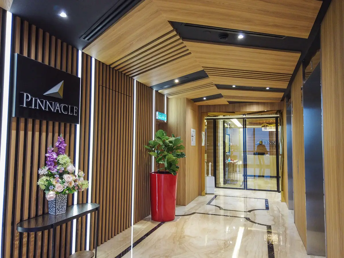 Lift lobby with timber slat walls, brand signage and marble flooring