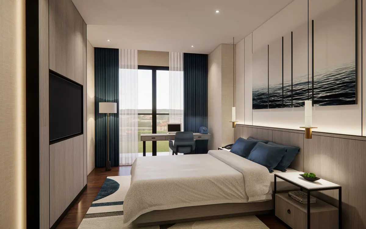 Bedroom with a dark feature wall, framed artwork and a study desk by the window