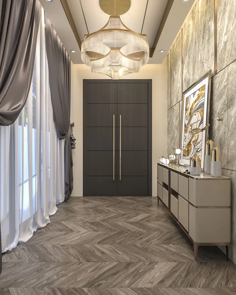 Entrance hall with tall dark doors, herringbone flooring and a console beneath framed art