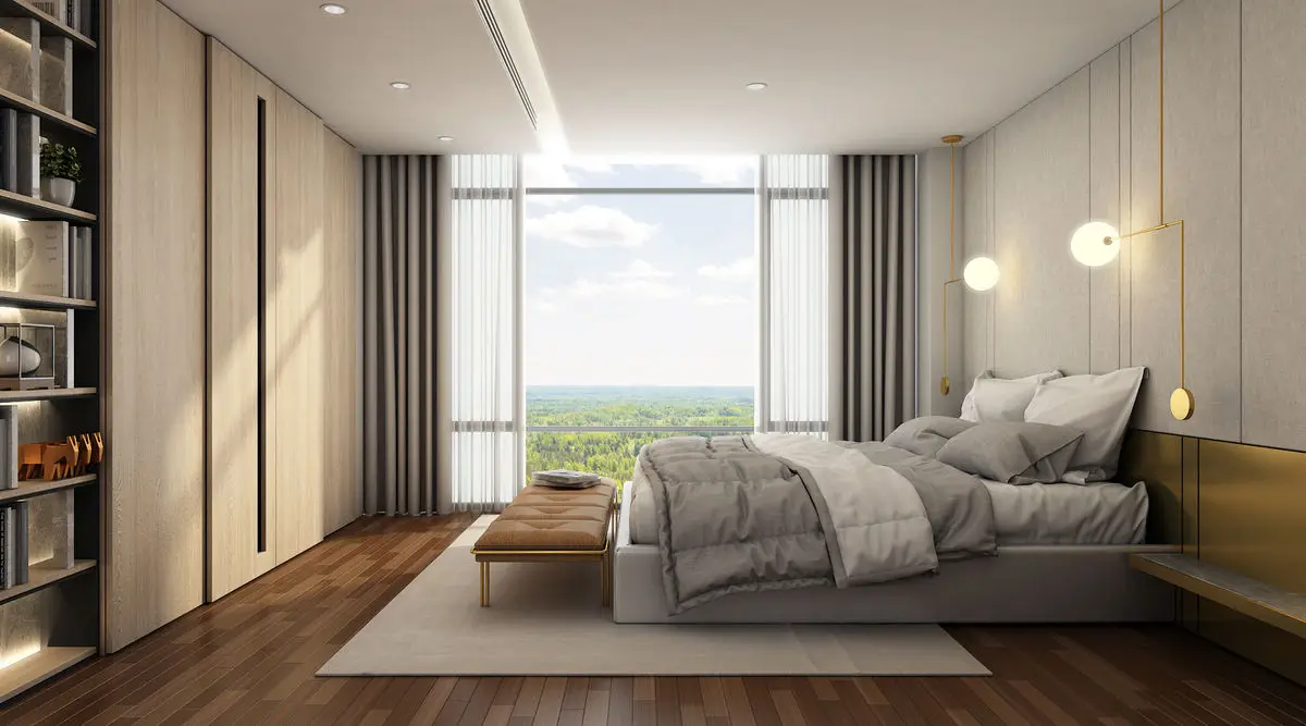 Bedroom with a padded headboard, open shelving and a wide window