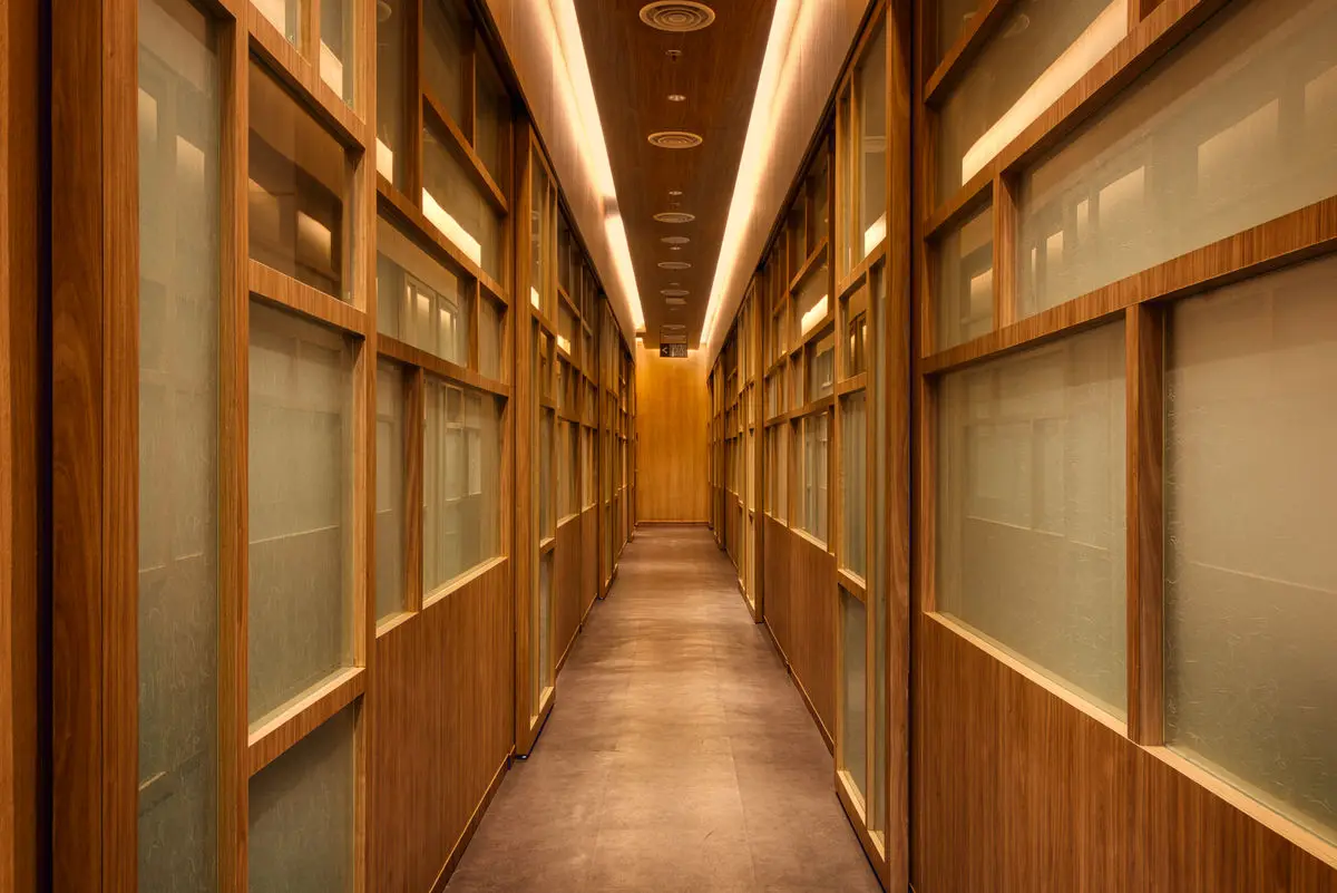 Corridor lined with shoji-style timber screens and warm lighting