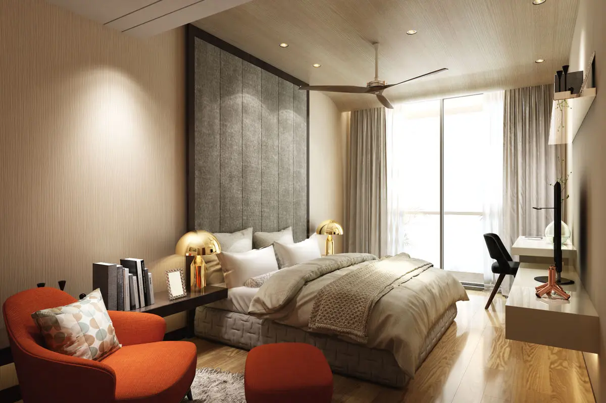 Bedroom with a textured headboard panel, orange armchair and a desk by the window