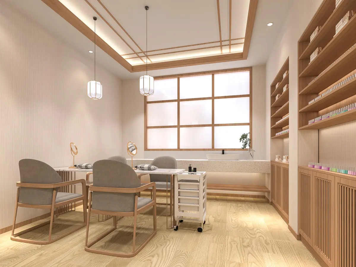 Nail salon area with pendant lights, treatment chairs and product shelving